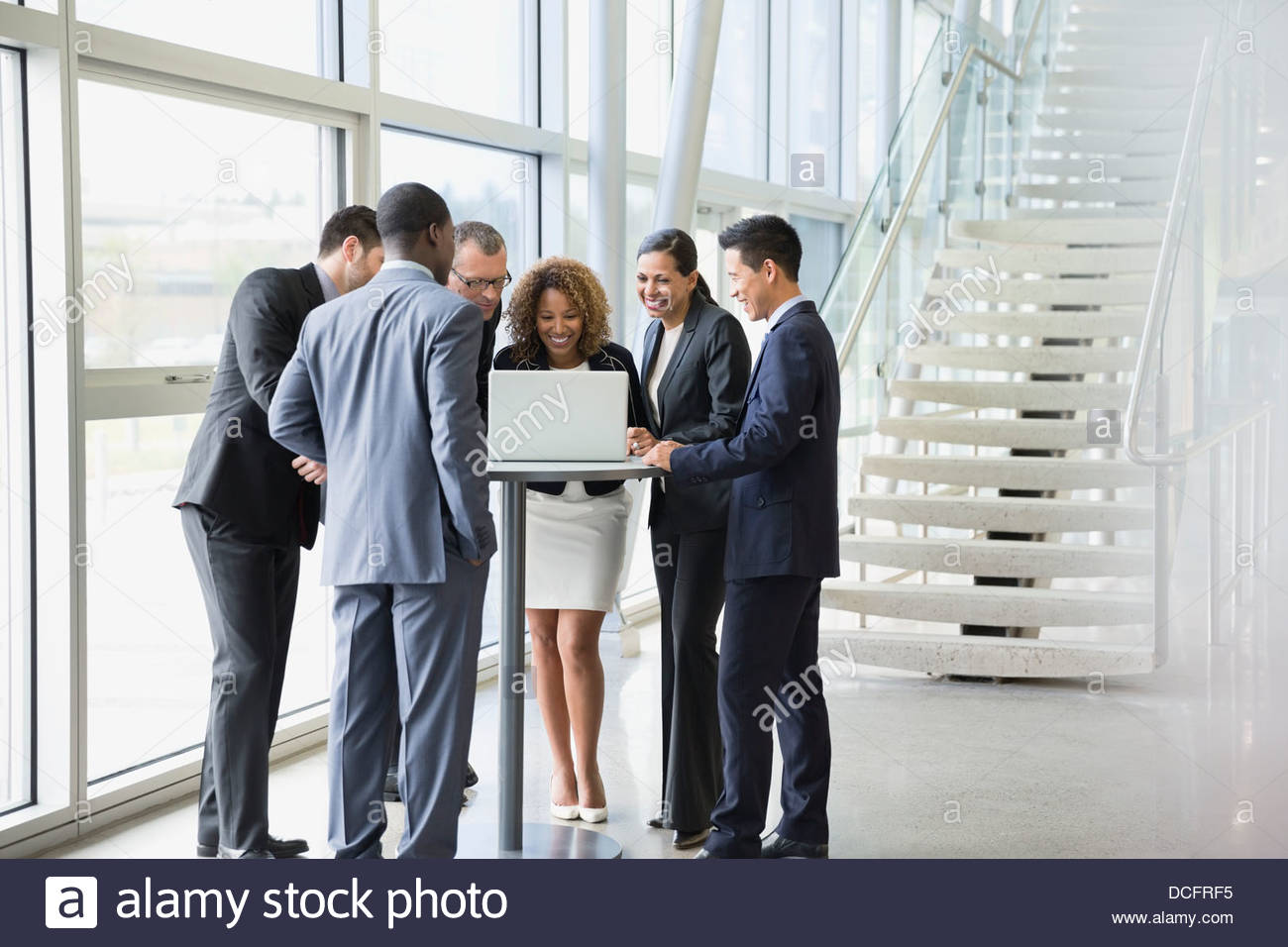 group-of-business-people-discussing-over-laptop-DCFRF5.jpg