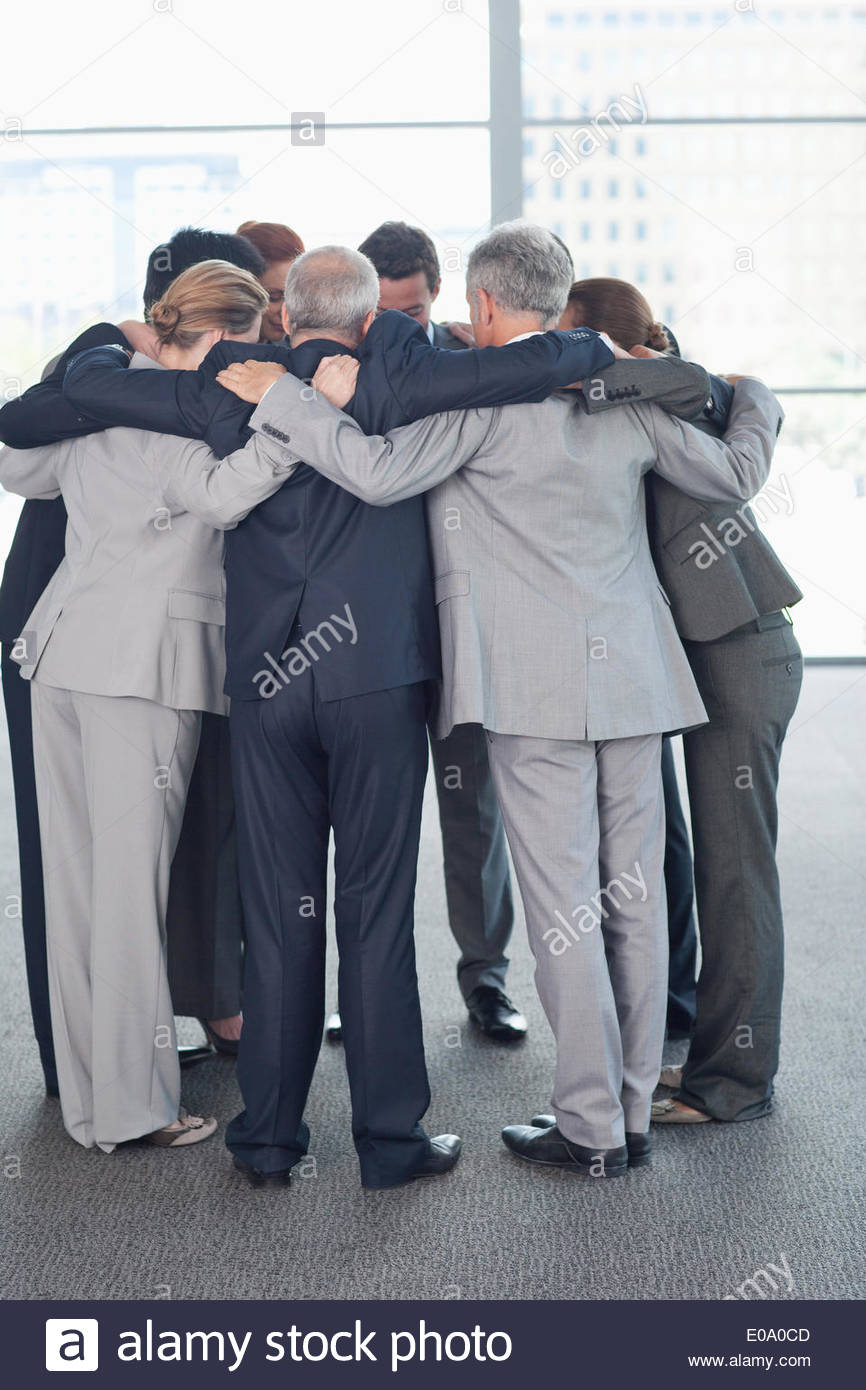 business-people-standing-in-huddle-E0A0CD.jpg