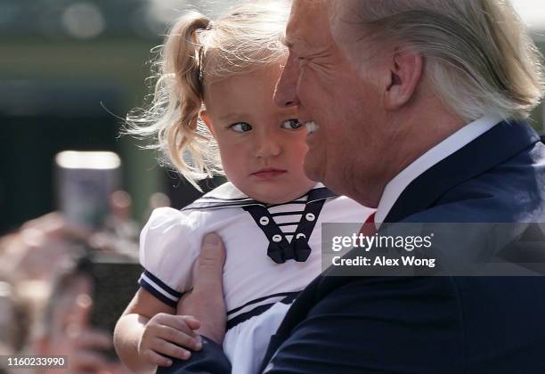 washington-dc-u-s-president-donald-trump-holds-a-girl-prior-to-his-departure-from-the-white.jpg